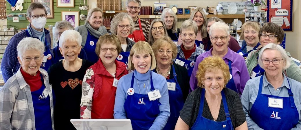 Assistance League member group photo at cash register